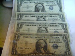 Four (4) Silver Certificates - 3 Uncirculate/1 Circulated photo