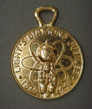 Key Tag - Light ' S Diamond Jubilee 1879 - 1954 (brass) photo