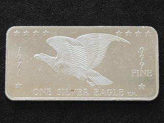 One Silver Eagle.  999 Silver Art Bar Ingot One Troy Ounce C8361 photo