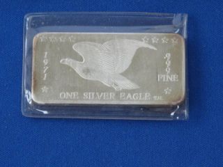 One Silver Eagle.  999 Silver Art Bar Ingot B0339 photo