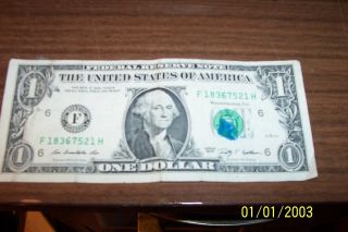 One Dollar Bill With Smear Mark On Stamped Seal. photo