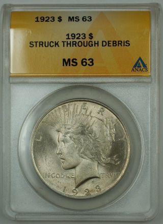 1923 Silver Peace Dollar Coin Anacs Ms - 63 Struck Through Debris Error photo