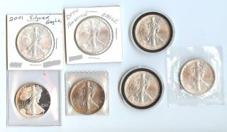 7 Uncirculated Silver Eagles - 1986,  1990,  1991,  1997 (2) 2000,  And 2001 photo