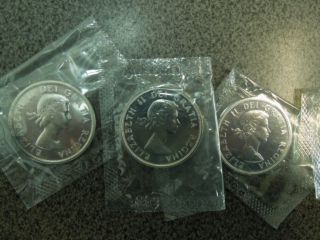 4 Uncirculated Canadian Dollars (3) Silver 1962,  1963,  1964 & (1) 68 ' Non photo