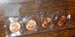 Four Uncirculated Canadian Copper Pennies - All Different photo