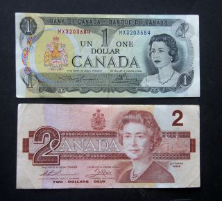 Canadian Currency $1 Note,  Series 1973 And $2 Note,  Series 1986 photo