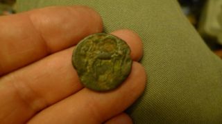 Ancient Bronze Greek Coin With Four Legged Animal On It photo