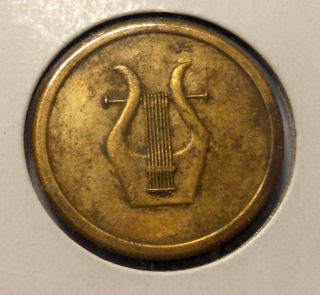 Unknown Bronze Metal Or Coin That Is 50 Cent Piece Size photo